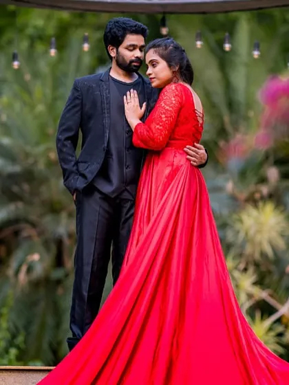 A romantic pre-wedding photo captured at an elegant outdoor location. The bride-to-be is wearing a stunning red trail gown, available for rent from my collection.
