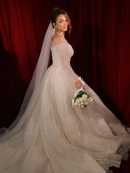 A final look back. The soft, romantic makeup and elegant gown create a truly memorable bridal moment.