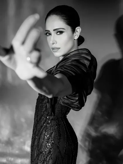 An expressive pose from the same monochrome series, where the hand reaching towards the camera adds depth and a dynamic element.