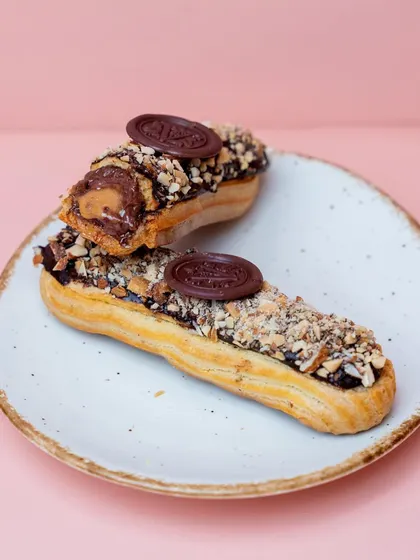 Our Roasted Almond Eclair. The light choux pastry is filled with an almond cream and topped with chocolate and toasted almonds for a delightful crunch.