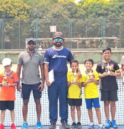 Our junior and senior players posing with their trophies and coaches after a great performance.