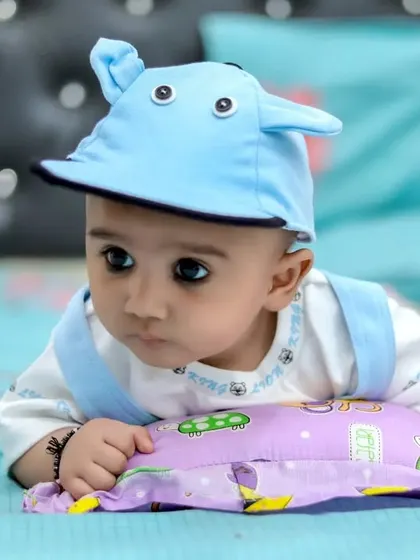 A thoughtful-looking baby during an indoor photoshoot. We take the time to capture a range of expressions, from joyful to contemplative.
