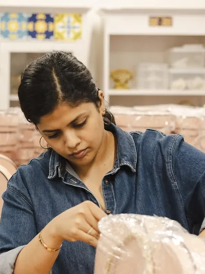Our co-founder Shruti carefully shrink-wrapping the heart-shaped boxes for the Hyundai order. This step ensures the products are secure and protected during transit.