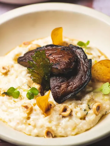 A creamy mushroom risotto, topped with a large grilled portobello mushroom. Earthy, rich, and deeply satisfying.