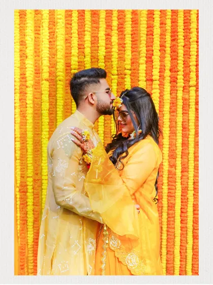 An intimate moment captured during the Haldi ceremony, with the groom placing a gentle kiss on the bride's forehead. These are the tender memories we strive to preserve forever.