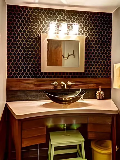This powder room features a dark, hexagonal tile accent wall and a unique curved wooden vanity. The design is compact but full of character and texture.