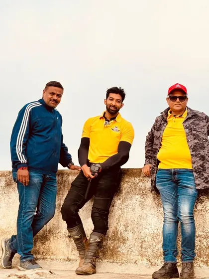 The crew posing on the rooftop of a fort built by Kempegowda, overlooking the surrounding landscape.
