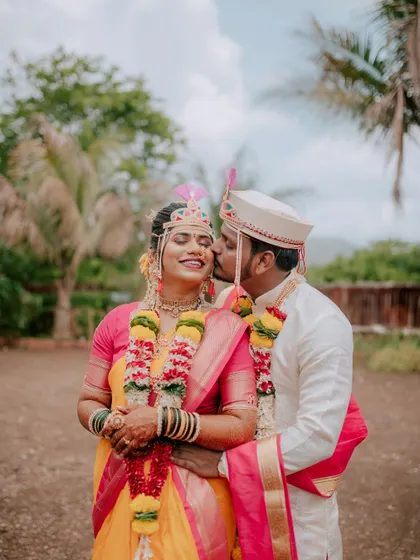 A sweet kiss on the cheek, a candid moment captured right after the wedding ceremony.