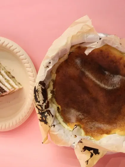 A top-down view of our rustic, eggless Burnt Basque Cheesecake next to a slice of our classic Tiramisu pastry.