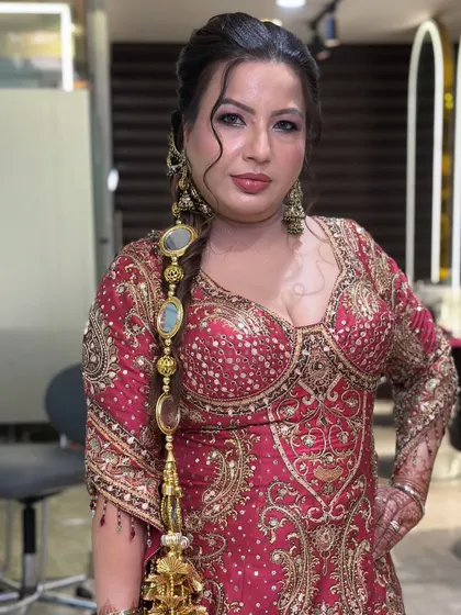 A closer look at the traditional Punjabi hairstyle with a decorative parandi and intricate braid, paired with flawless makeup.