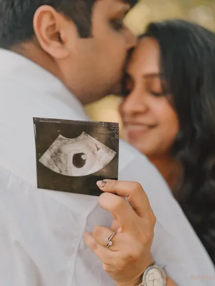 A close-up on the first glimpse of their baby. This tender photo, with a loving kiss in the background, is filled with so much hope and love.