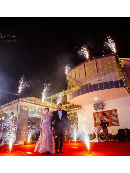 The grand entrance. The bride and groom make a statement at their cocktail party, with her shimmering gown and his classic tuxedo.