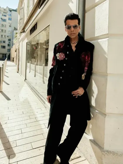 A full-length view of the bespoke Indowestern floral jacket worn by Karan Johar. The elongated silhouette and striking embroidery make it a powerful statement piece for any major event.