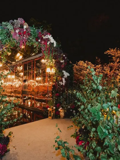 A look inside a glamorous red and maroon themed cocktail night, with velvet textures, a custom poker theme, and a stunning floral-decked bar.