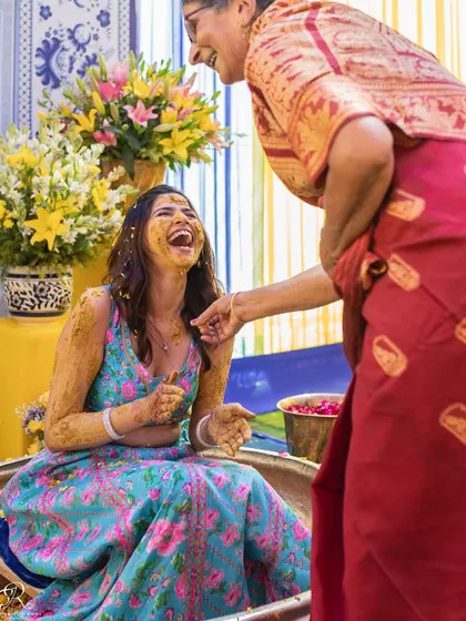 A beautiful, candid moment between the bride and an elder family member during the Haldi.
