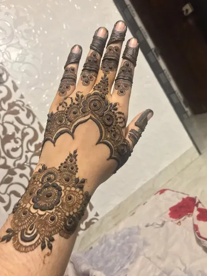 A beautiful design that looks like jewelry on the hand, with a cuff and hanging elements.