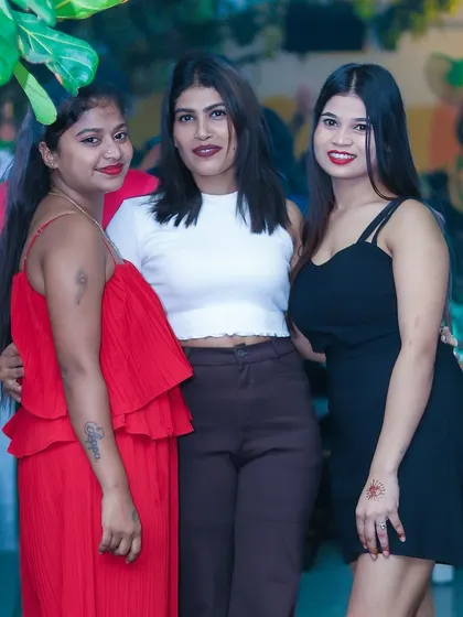 A stylish group of friends dressed in red and black, ready for a fun night.