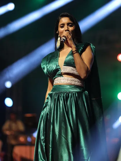 Another angle of the performance, showing the details of the pleated top and the flowy skirt.