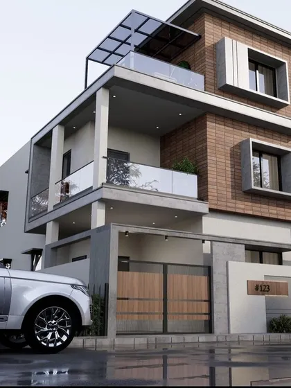 This architectural design combines brick cladding with white and grey surfaces. The rooftop pergola and glass balconies add modern elements to the warm, textured facade.
