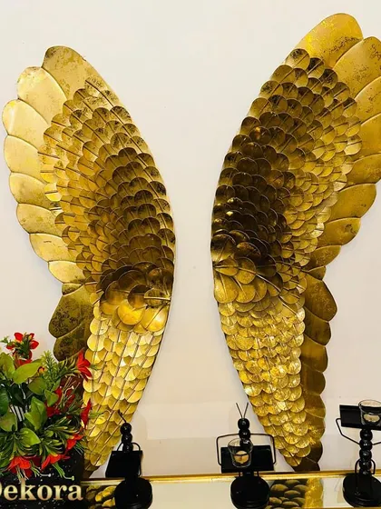 These large, golden metal angel wings make a dramatic and inspiring statement piece. The detailed feathering gives them a realistic and textured look.