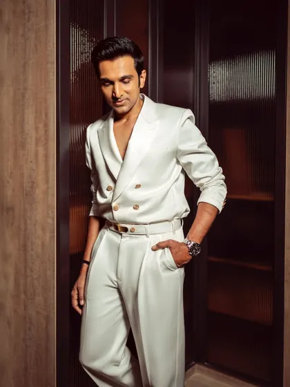 A moment of reflection. Pratik Gandhi in our tailored white ensemble, a look that perfectly balances bold styling with sophisticated elegance.
