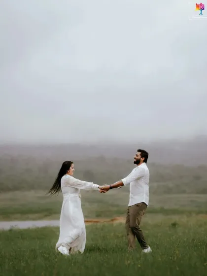 A candid shot of a couple dancing in a misty field, their joy and movement creating a beautiful, spontaneous portrait.