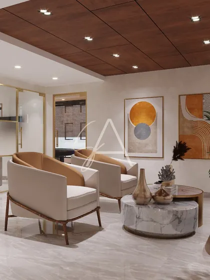 A close-up of the seating arrangement in the visitors' lounge. The mix of a sofa and armchairs creates a conversational and comfortable setting for guests.