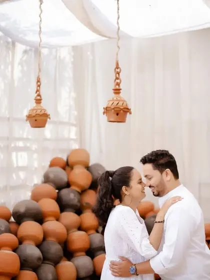 United by love. An intimate moment in a beautifully rustic set filled with earthen pots. The soft, diffused light creates a warm and romantic atmosphere.