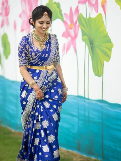 A duplicate of image 104, showing the bride in her stunning royal blue Banarasi saree and custom silver-embroidered blouse.