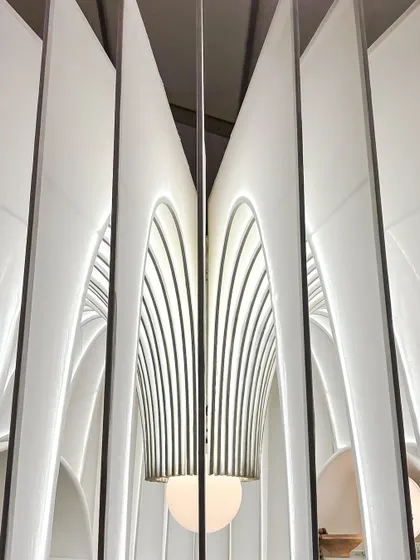 A closer look at the heart of our fabric sanctuary. We designed the central light fixture to complement the gracefully arching fins of the structure. This detail shows our commitment to making every element, from the grand architecture to the delicate lighting, part of a single, cohesive story.