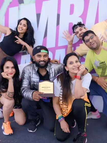 Receiving a token of appreciation at the 'Zumba for a Cause' event. It's an honor to be part of a team that uses fitness to make a positive impact.