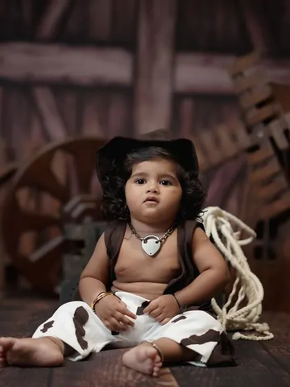 This cowboy-themed shoot was for a first birthday. The rustic backdrop and props create a unique and memorable way to celebrate the 'ONE' milestone.