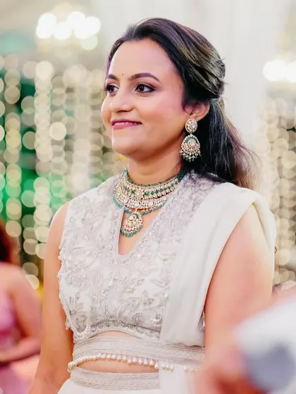 I love this elegant all-white look. The makeup features a slightly bolder eye to complement the simple color palette, creating a chic and modern bridal statement.