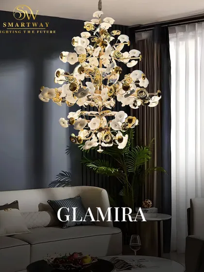 The Glamira chandelier features a cascade of white and gold petals, creating a luxurious and organic feel. It's a perfect statement piece for a living room with high ceilings.