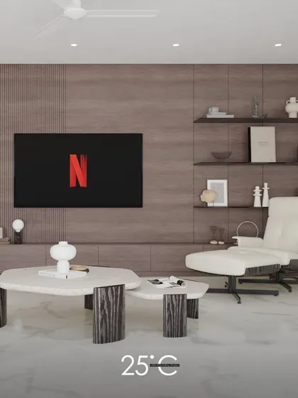A detail shot focusing on a comfortable reading corner. The image highlights the plush off-white lounge chair and the uniquely designed nested coffee tables, emphasizing our commitment to creating stylish and functional nooks for relaxation.