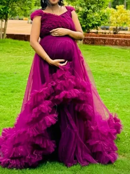 A beautiful shot of the magenta ruffle gown, showing its high-low design. This is a great option if you want to show off your footwear while still having a dramatic train.