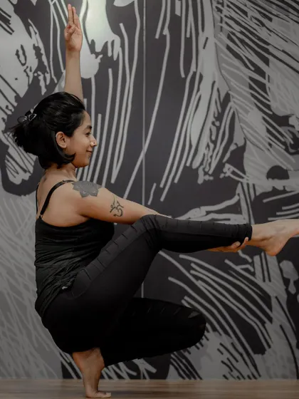 Finding balance and a bit of fun in this variation of a toe stand. The unique mural in the studio adds a creative energy to our practice, reminding us to stay playful.