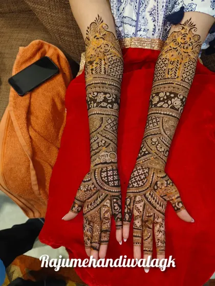 A full-arm design with a mix of floral, paisley, and geometric patterns. The couple's initials are subtly included on the arm.