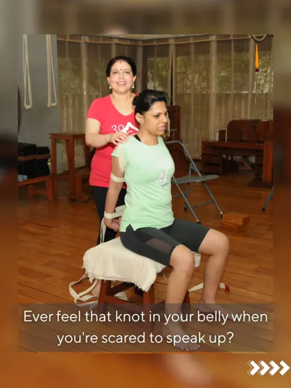 Ever feel that knot in your belly when you're scared to speak up? That's a blockage in your Manipura chakra. Here, a student uses a chair and belt to open her shoulders and chest, releasing tension and building the confidence to find her voice.