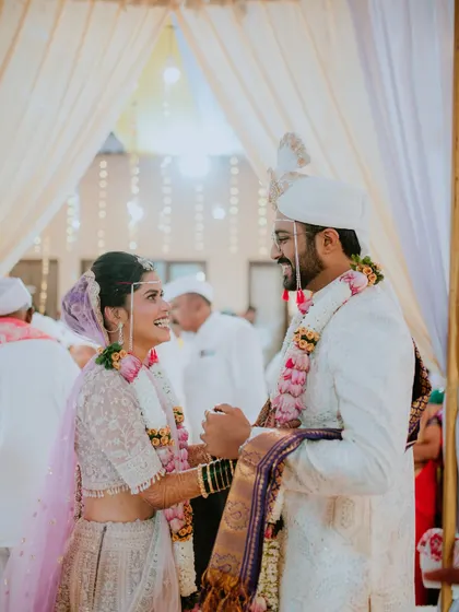 A happy, candid moment between the bride and groom right after their Varmala ceremony.