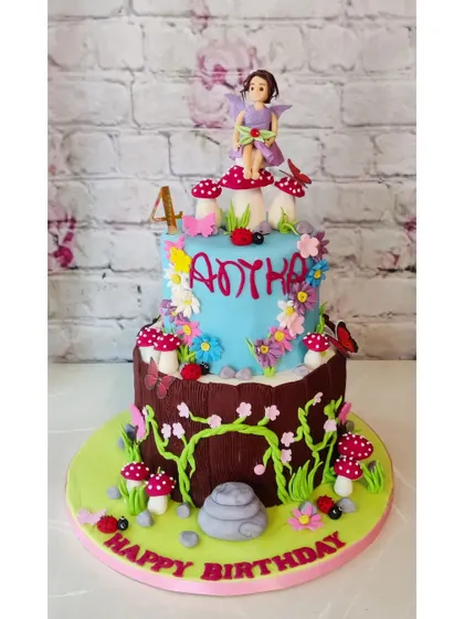 Another take on a fairy garden theme, this two-tier cake for Anyha's 4th birthday is full of whimsical details like mushrooms, flowers, and a sweet little fairy on top.
