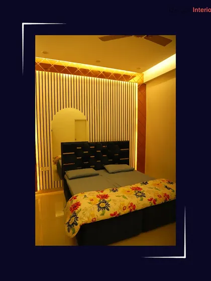 A modern bedroom featuring a unique accent wall with vertical slats and an arched mirror. The warm backlighting creates a cozy and inviting atmosphere.