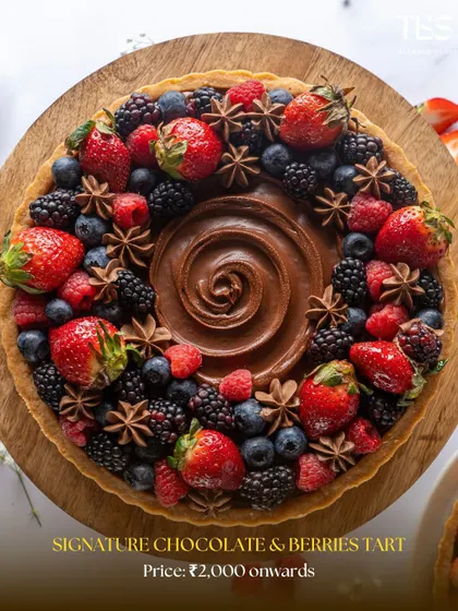 My Signature Chocolate and Berries Tart, a year-round bestseller. The mix of seasonal berries provides a beautiful contrast to the deep, dark chocolate filling.