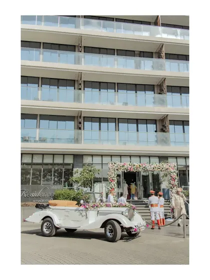 The groom's grand arrival in a beautifully decorated vintage car. This shot captures a touch of old-world charm and luxury at the Oxford Golf Resort.