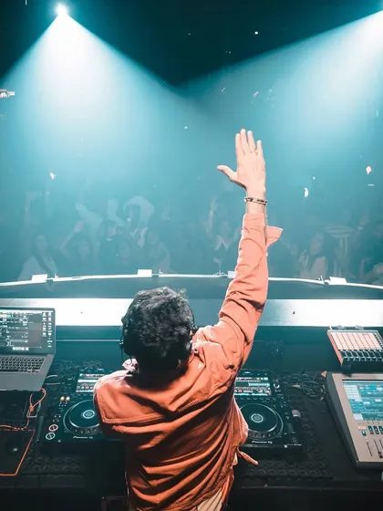 A view from behind the decks at Hammerzz in Goa, waving to the energetic crowd.