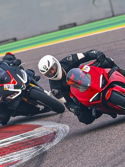 A tight pack of riders, including two Ducati Panigales, diving into a corner. This is where you test your skills against fellow enthusiasts.