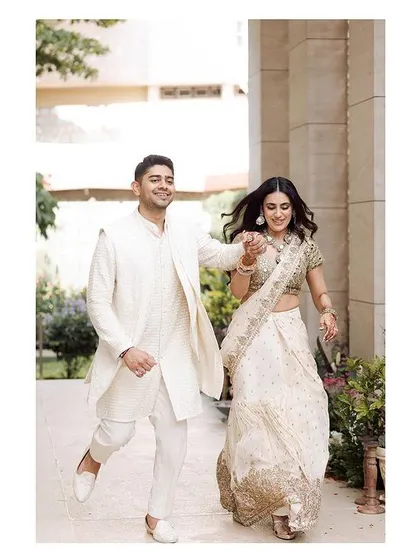 A candid shot of the couple, full of joy, during their intimate home engagement ceremony.