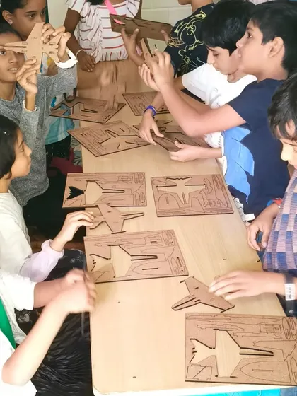 The assembly line of young engineers is hard at work on their fighter jet models. They are learning how to follow instructions and fit pieces together perfectly.