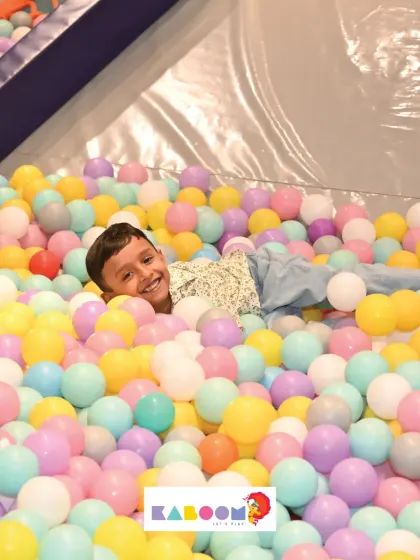 A happy smile from the middle of the ball pit. It's impossible not to have fun in here!