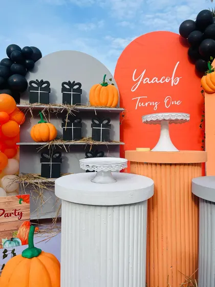 A detailed look at the dessert and gift station for the pumpkin party, featuring custom-wrapped gifts and themed decor.